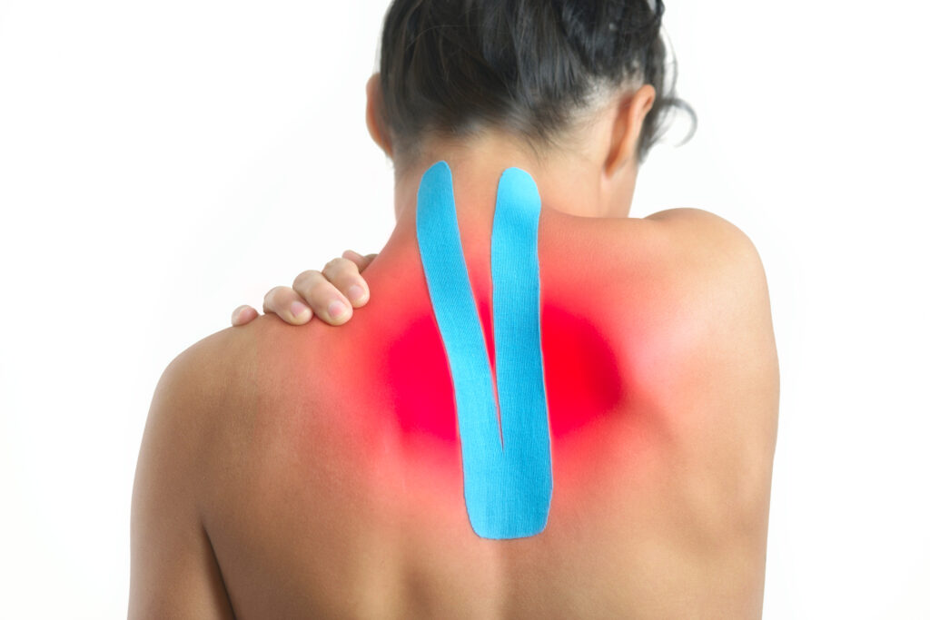kinesiology taping physical therapy treatment, physical therapist applying kinesio tape