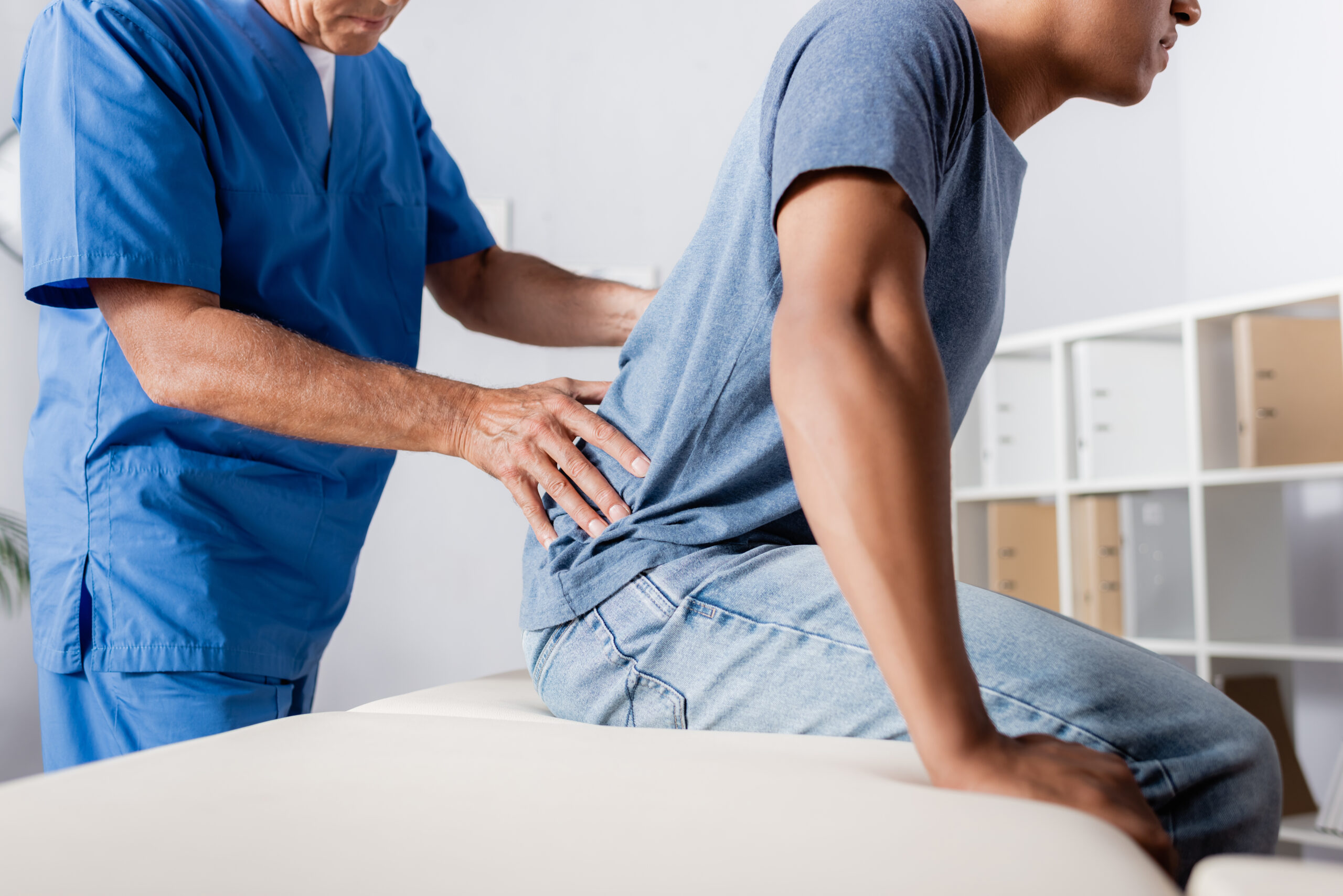 physical therapist working with man on low back pain relief